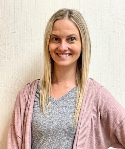Headshot of Jenn, our Administrative Assistant smiling in the office