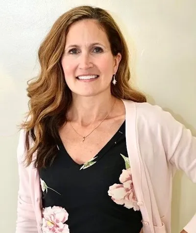 Headshot of Kelly, our Anesthesia Assistant, smiling in the office